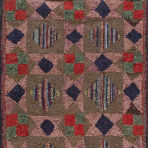 Rustic high-pile rug with geometric brown, pink, navy, and multicolored striped diamond shapes.