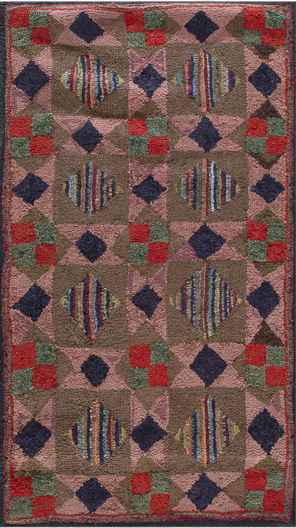Rustic high-pile rug with geometric brown, pink, navy, and multicolored striped diamond shapes.