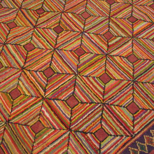 A vividly striped rug with a repeating geometric diamond pattern and a decorative dark purple border.