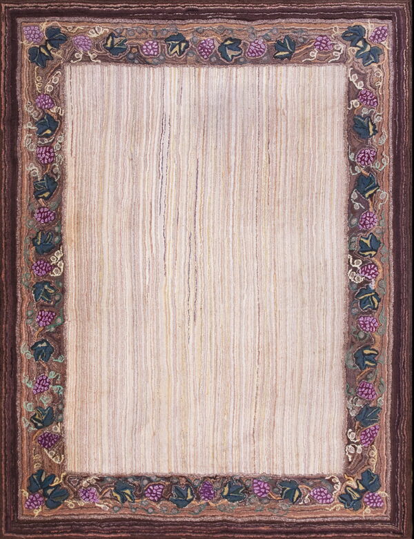 Rectangular rug with a striped neutral field and a wide border of purple berries and dark green leaves.