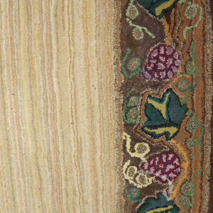 Heavily textured rug with a light striped field and a dark floral vine border in purple, green, and brown.