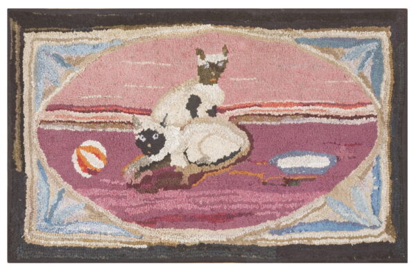 Textured hooked rug featuring two cats and a ball within a magenta and pink oval design.