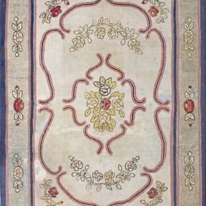 Light beige rug with a gray border, featuring a detailed floral design in red, pink, and blue.
