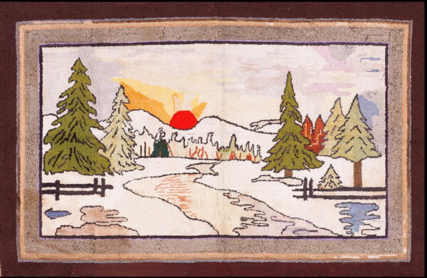 Hooked rug with a scenic pattern of green trees, snow, a red sun, and a wide multicolored border.