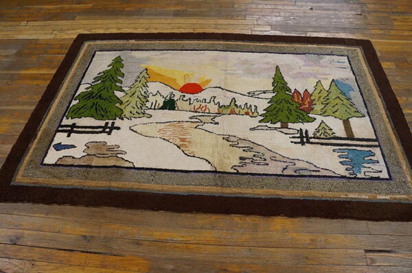 Low-pile rug depicting a rustic landscape of trees, stream, and sunset, framed by thick brown borders on wood floor.
