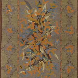 Taupe hooked rug with a central orange and blue floral spray framed by an olive geometric border.
