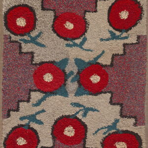 High-pile rug with red floral motifs, teal leaves, and stepped geometric borders on a heathered gray field.