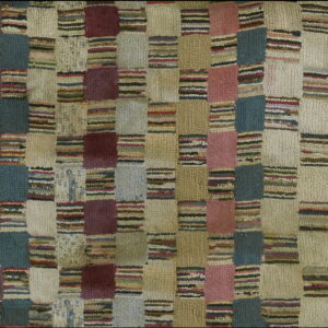 High-pile rug with a checkered grid pattern in muted teal, burgundy, mauve, cream, and multicolored stripes.