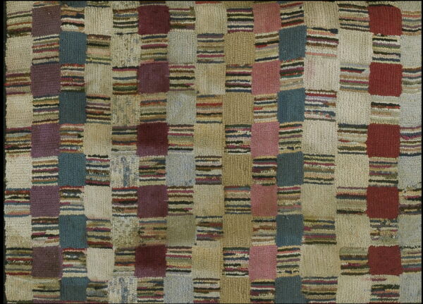 High-pile rug with a checkered grid pattern in muted teal, burgundy, mauve, cream, and multicolored stripes.