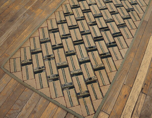Textured beige runner rug with a striped, rectangular geometric pattern sits atop rustic plank flooring.