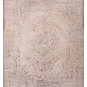 Light beige rug featuring a central floral medallion surrounded by a chunky basketweave border design.