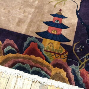 Sculpted high-pile rug displaying a pagoda and multicolored mountains rests on light wood floors.