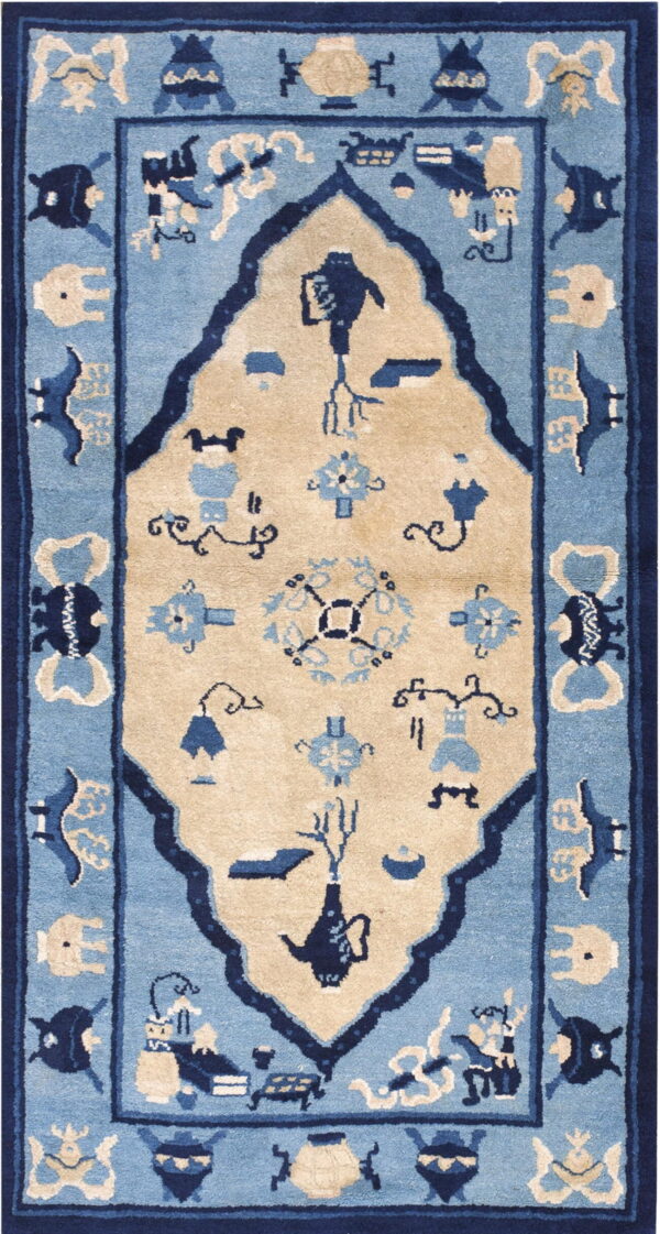 Rectangular rug with a beige ogival medallion on a light blue field and dark blue border.