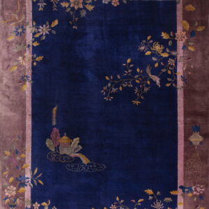 Deep blue rug with an ornate pagoda motif, birds, and a wide dusty rose floral border.