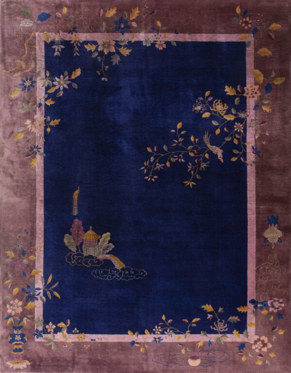 Deep blue rug with an ornate pagoda motif, birds, and a wide dusty rose floral border.