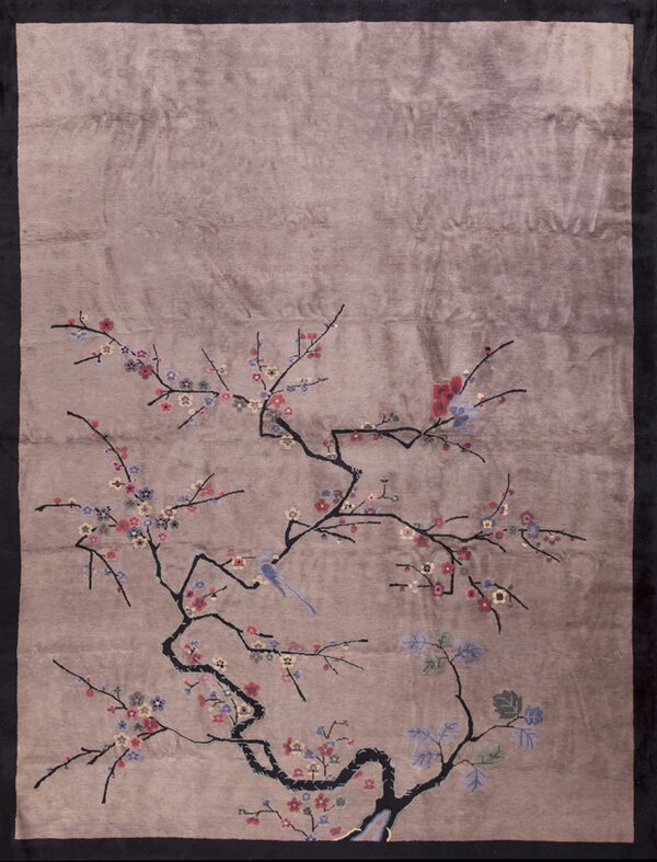 A glossy taupe rug featuring a detailed branch pattern with small multicolored flowers and a blue bird.