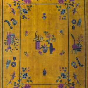 High-pile yellow rug displaying detailed purple and blue floral motifs and decorative objects on wood planks.