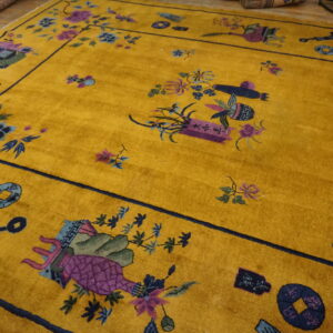 A vibrant yellow rug with high pile features scattered purple and blue traditional motifs and a dark border.