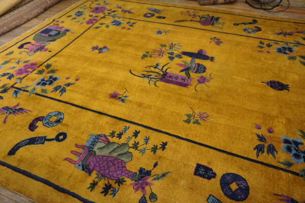 A vibrant yellow rug with high pile features scattered purple and blue traditional motifs and a dark border.