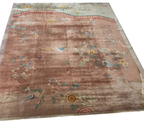 Red knotted antique 1920s room size wool rectangle chinese - art deco rug 5 Distressed rug featuring a faded pink and brown scenic pattern of birds, flowers, and a central bridge.