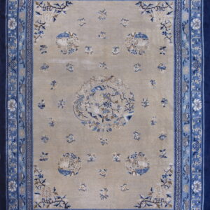 Beige rug with bird and floral medallions, framed by intricate layered borders in shades of blue.