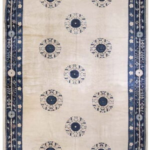 Long cream rug featuring repeating navy medallions and wide intricate blue and white borders.