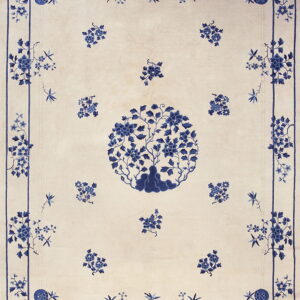 Blue and white rug with a central floral tree medallion and detailed floral borders.