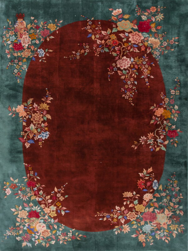 Plush teal rug with a central maroon oval field framed by colorful floral vines.