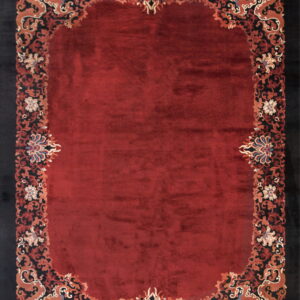 High-pile red rug with an elaborately scrolled black border patterned with stylized orange dragons and flowers.