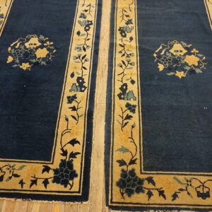 Two dark blue runners with gold floral borders are positioned side-by-side on light wood flooring.