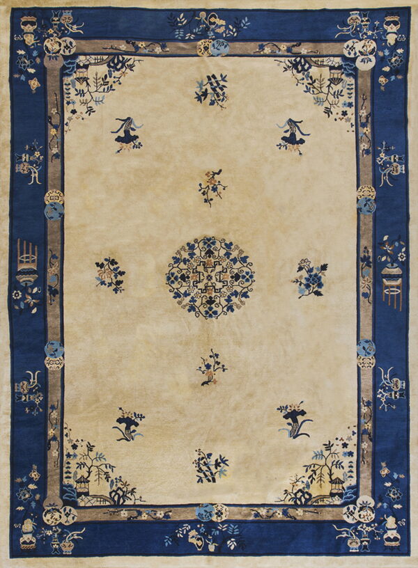Beige high-pile rug with dark blue borders and scattered traditional floral and medallion patterns.