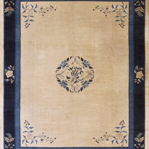 Light beige rug detailed with a central blue floral medallion and thick dark blue botanical borders.