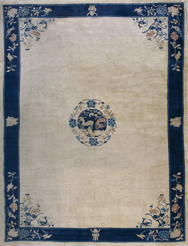 Cream rug with a navy blue border, corner florals in blue and pink, and a central animal motif.