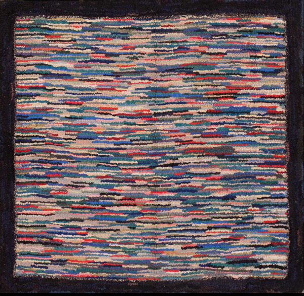 Multi-colored, textured rug with horizontal stripes in blue, red, teal, and beige, framed by a solid dark border.
