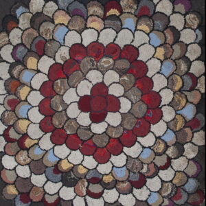 Highly textured rug featuring a central red flower pattern surrounded by rings of scalloped, multicolored patches.