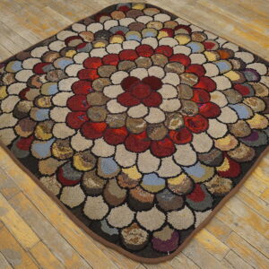 Textured, multicolor diamond rug with loop-pile pebble shapes and a red center on yellow wood flooring.