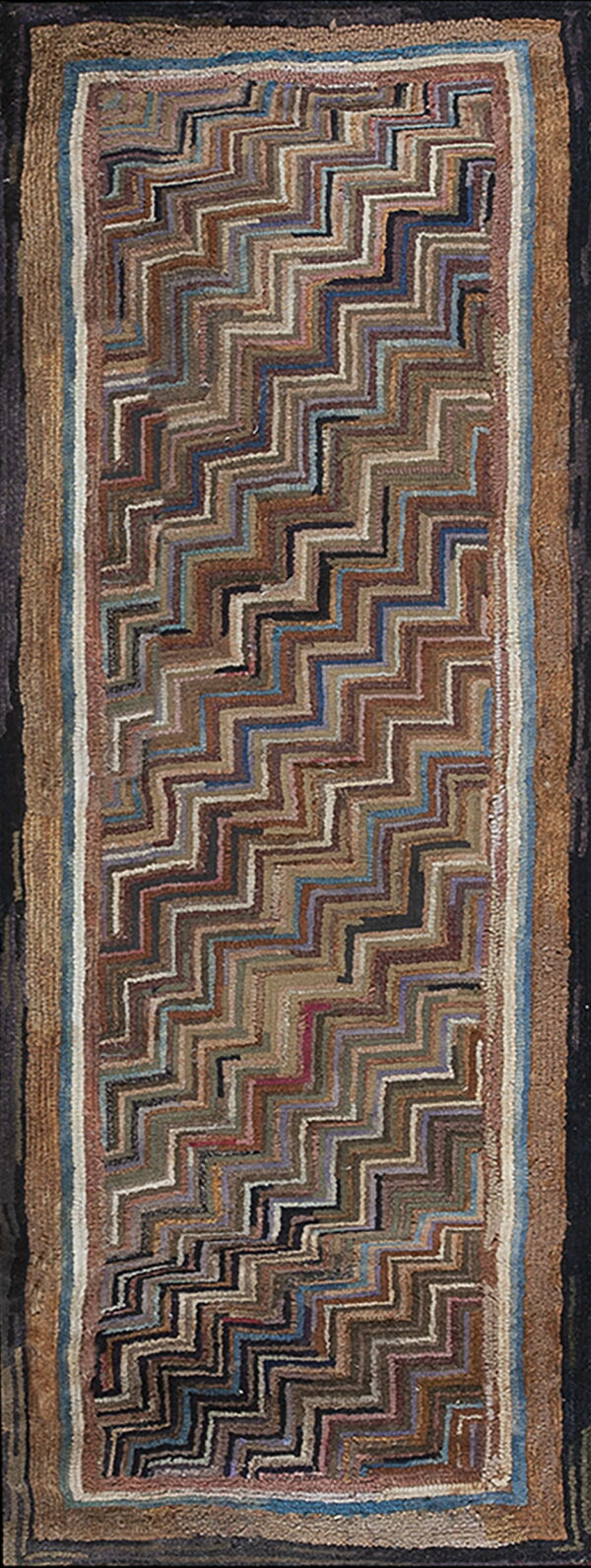 Highly textured runner rug with a diagonal zigzag pattern in mixed brown, blue, and tan shades.