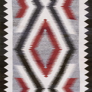 Geometric flatweave rug featuring serrated diamonds in red, black, gray, and white colors.