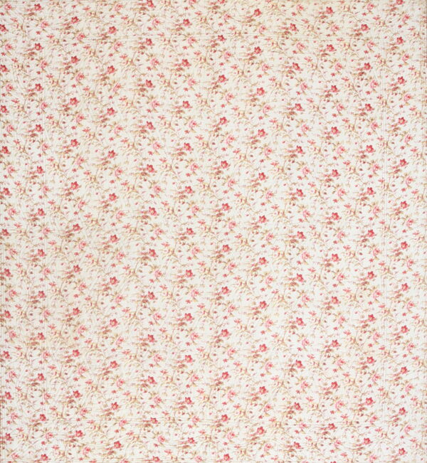 Cream rug with a dense pink and red floral pattern and a distinct overall quilted texture.
