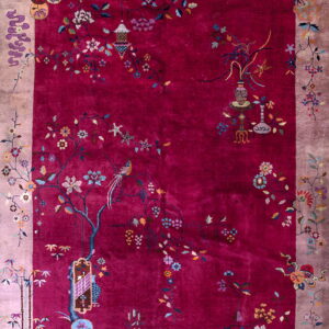 Berry red rug with a wide mauve border and a vibrant, detailed pattern of flowering branches and birds.