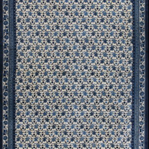 Blue and cream rug with repeating cloud patterns and ornate geometric and stylized border bands.
