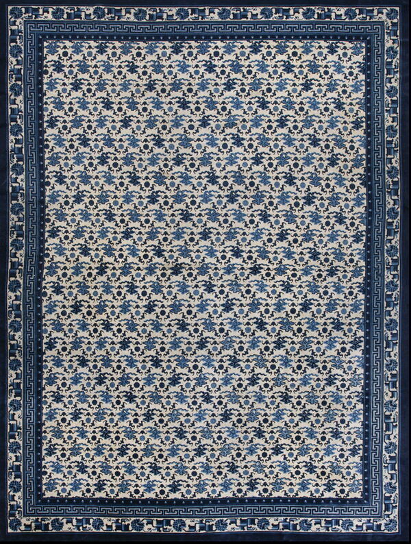 Blue and cream rug with repeating cloud patterns and ornate geometric and stylized border bands.