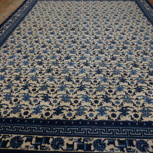 Cream and blue rug featuring a repeating cloud pattern and geometric borders on wood flooring.
