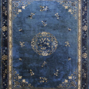Deep blue rug featuring a central floral medallion and intricate borders in navy and gold beige.