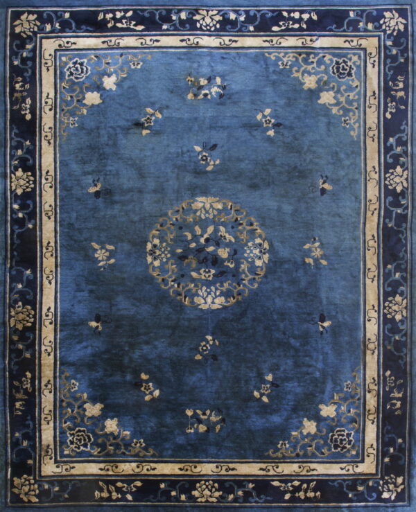 Deep blue rug featuring a central floral medallion and intricate borders in navy and gold beige.