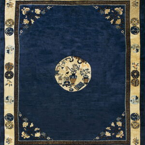 Navy blue rug with a cream border featuring circular medallions and a central pictorial circle.