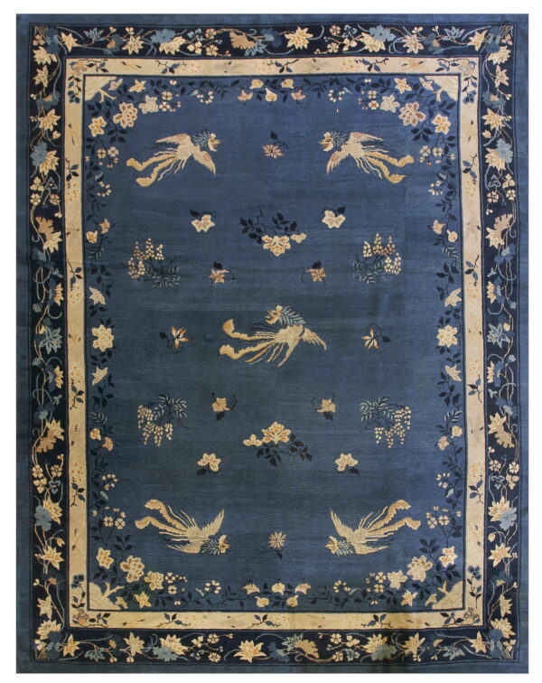 Dark blue rug with stylized gold birds and scattered floral elements inside a cream and dark blue border.