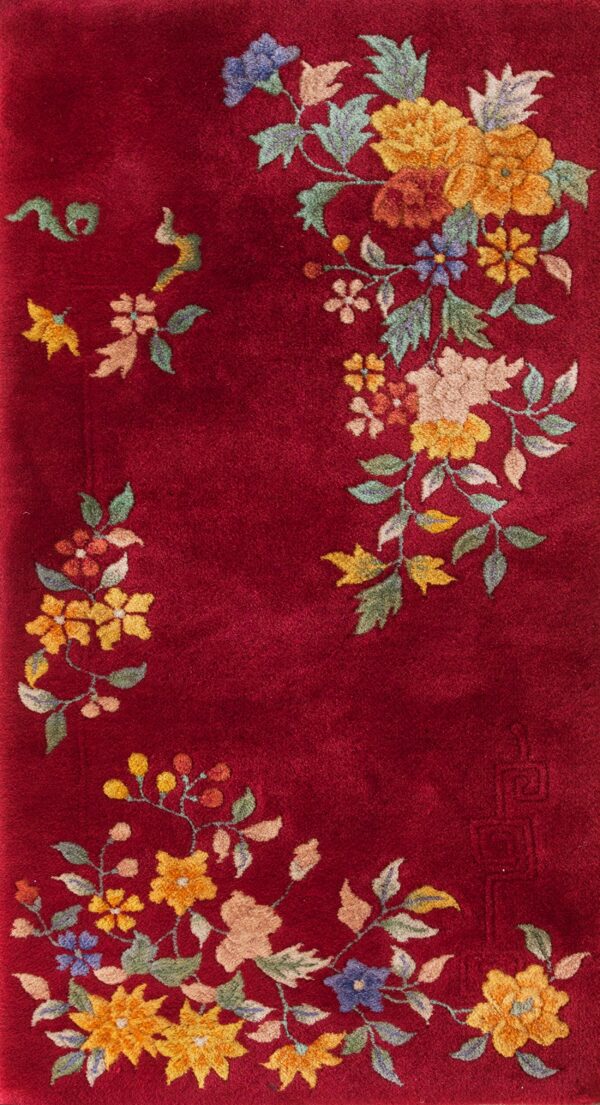 Burgundy runner rug featuring corner floral sprays in yellow, blue, and green on white tiles.