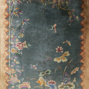 Teal and tan rug featuring an elaborate Chinoiserie design with bamboo, flowers, and butterflies.