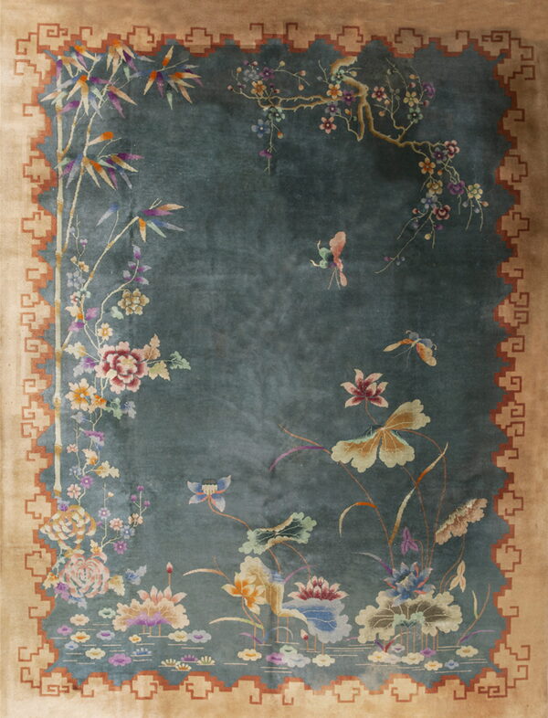 Teal and tan rug featuring an elaborate chinoiserie design with bamboo, flowers, and butterflies.